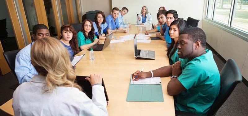 Nurses and Doctors Around a Table Collaborating